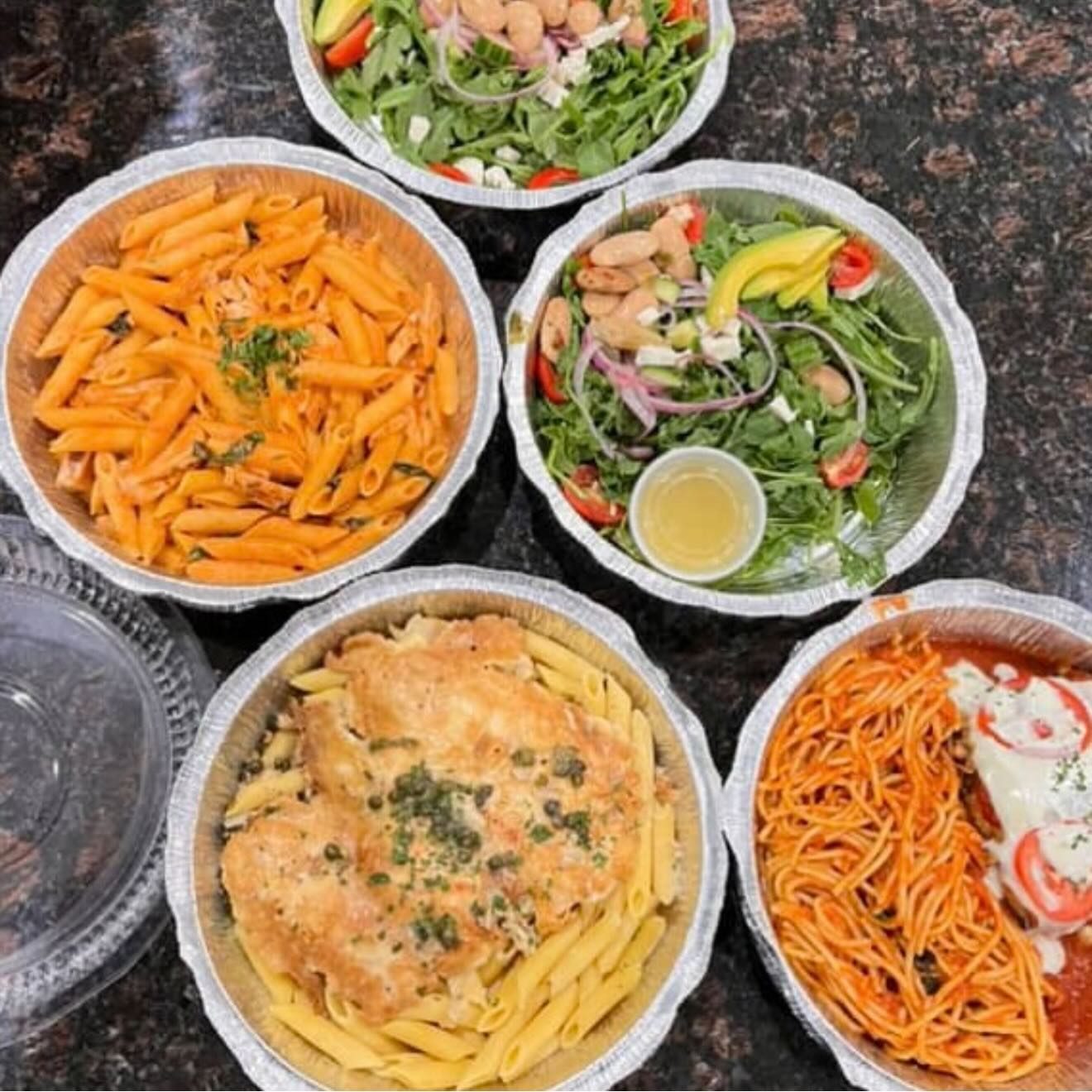 Catering pans of penne alla vodka, chicken piccata, butter bean salad and parmigiana