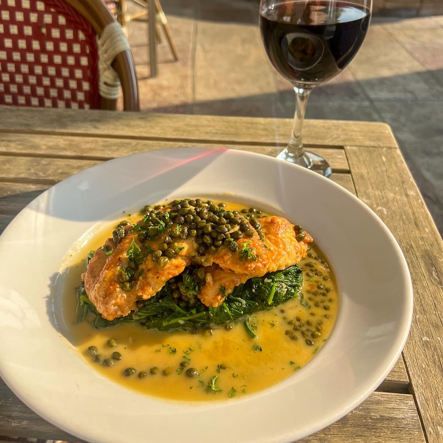 Piccata with capers over spinach